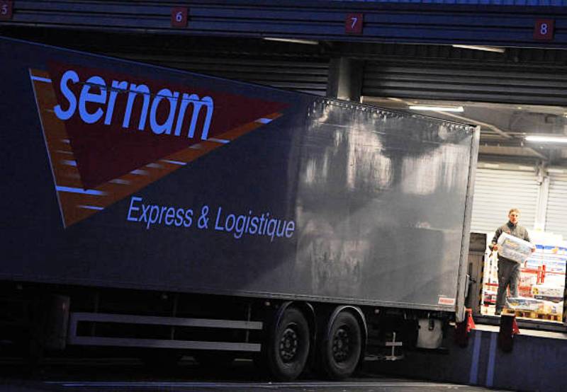 A worker of the French cargo transport fret service Sernam loads parcels onto a truck, in Sainghin-en-Melantois, northern France, on January 30, 2012.  Sernam, which employs 1.600 people, is threatened of bankrupcy, and announced today it will ask for receivership. AFP PHOTO PHILIPPE HUGUEN (Photo credit should read PHILIPPE HUGUEN/AFP/Getty Images)
