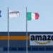 FILE PHOTO: Flags flutter outside a distribution centre, during a strike at Amazon's logistics operations in Italy, in Passo Corese, Italy March 22, 2021. REUTERS/Remo Casilli